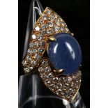 An 18ct gold, cabouchon sapphire and diamond set cocktail ring