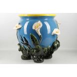 A large 'Majolica' ceramic jardinière with applied lilies and and swallows on a sky blue ground,