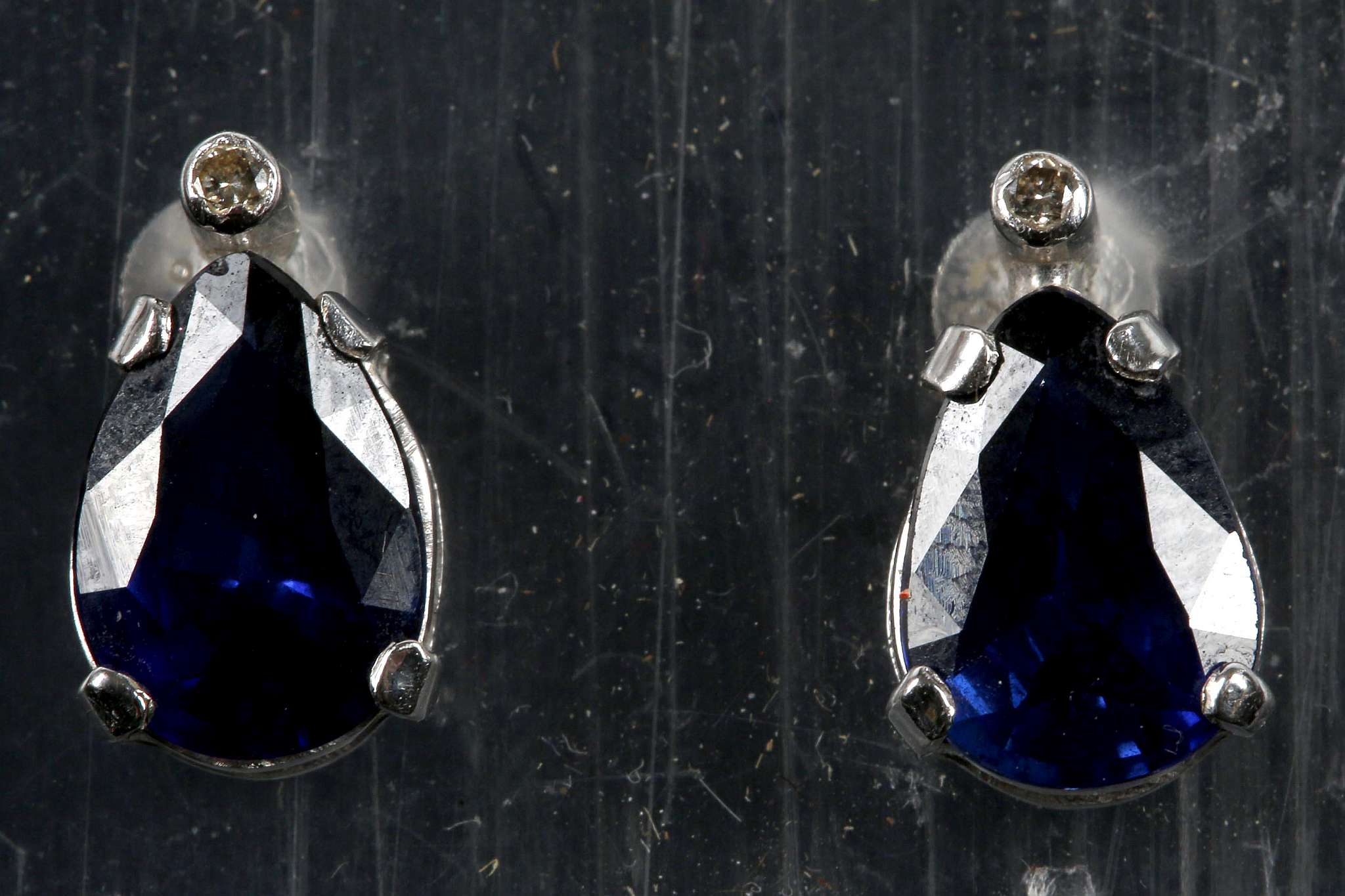 A pair of 14k white gold, diamond and sapphire set earrings (Note: sapphires presumed treated?)