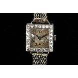 A platinum, cased square faced ladies cocktail watch, the square face surrounded by diamonds, with