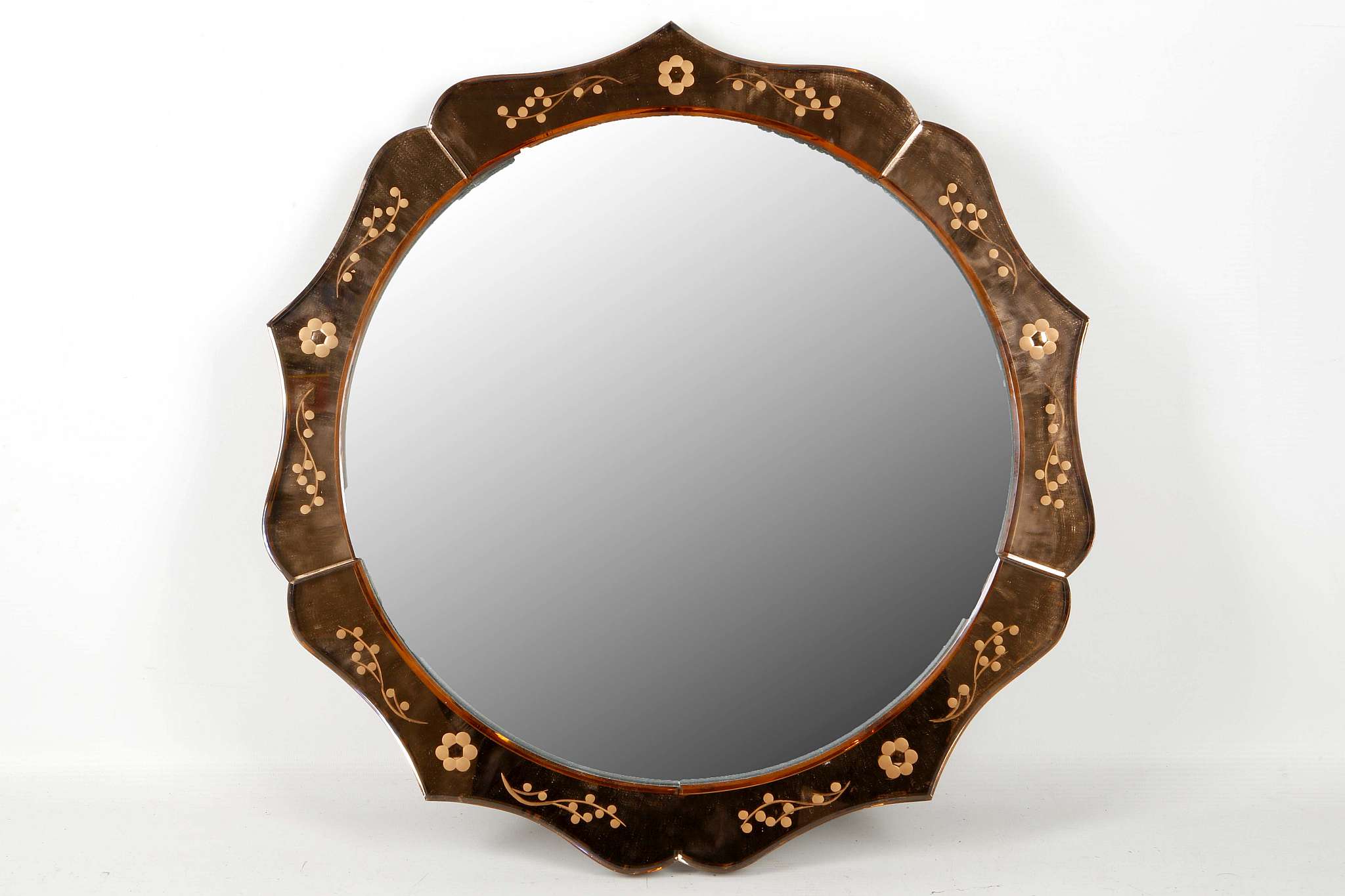 An Art Deco, multi arched top mirror with peach glass slips, a convex mirror with peach glass