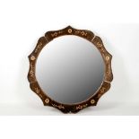 An Art Deco, multi arched top mirror with peach glass slips, a convex mirror with peach glass