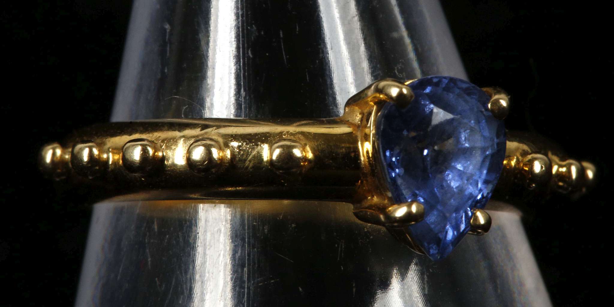 An 18ct gold, and per cut sapphire solitaire ring