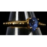An 18ct gold, and per cut sapphire solitaire ring