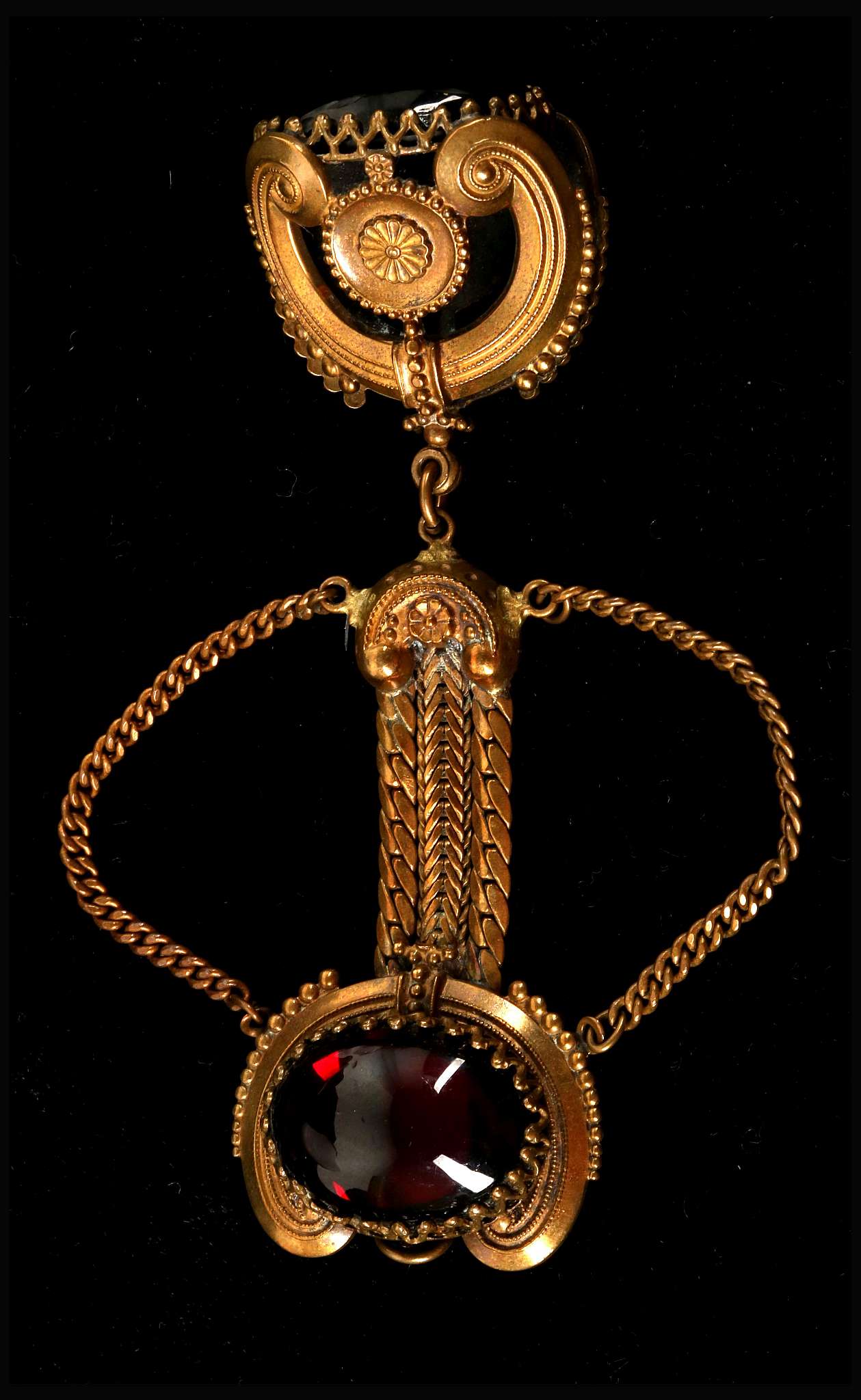 A c.1940's Karm pendant brooch, in the form of a fob seal in gilt metal and set with garnet coloured