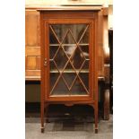 A small Edwardian display cabinet, satinwood inlay of banding, astraglaze door, tapering block legs,