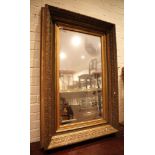 A large giltwood picture frame, now fitted with a