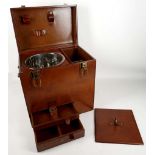 A leather travelling box with brass fittings, for wine and cigars