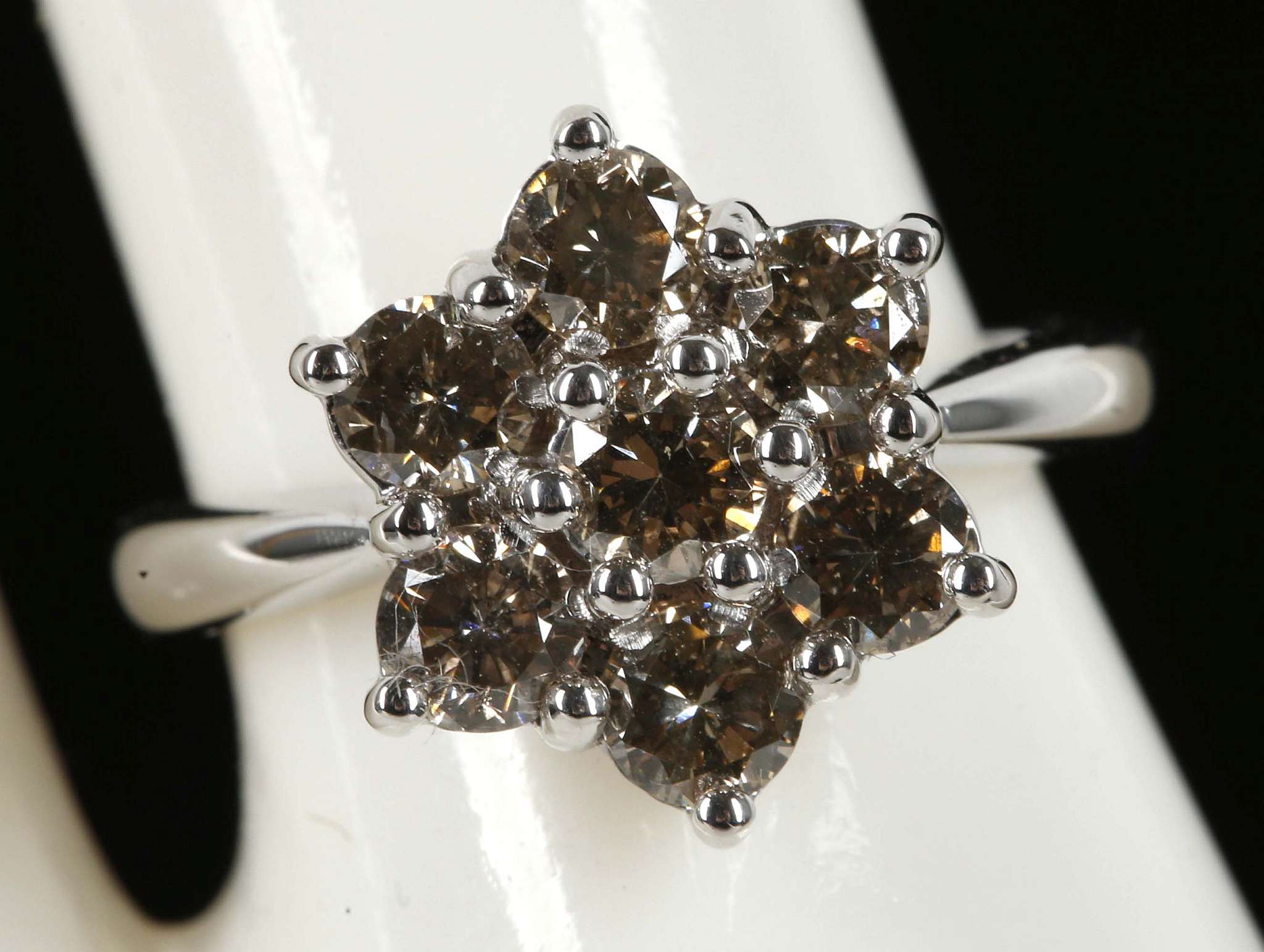 An 18ct white gold, 7 stone diamond champagne cluster ring, 1.42ct