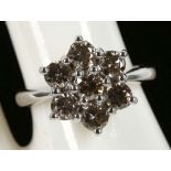 An 18ct white gold, 7 stone diamond champagne cluster ring, 1.42ct