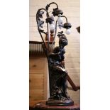An Art Nouveau style maiden lamp, tri-light leaf decorated, 83cm high, and a mahogany finish