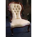 A mahogany salon chair, fruit and nut carving to back, silk decorated buttonback acanthus