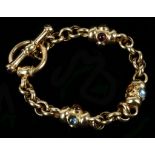An 18ct gold fancy link bracelet, set with cabouchon garnets, citrine, topaz and peridot