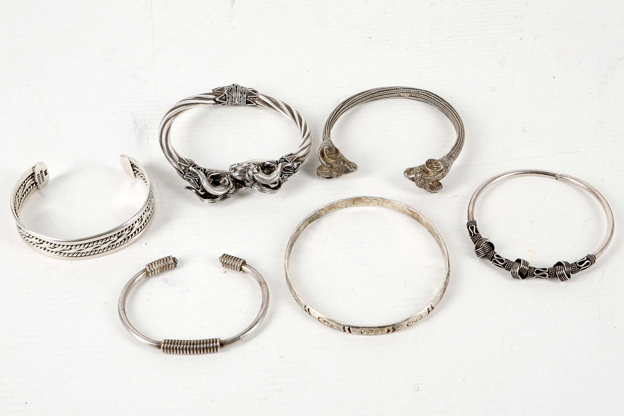 Six various .925 silver bracelets / bangles including hinged rams head cross-over, Mexican sun