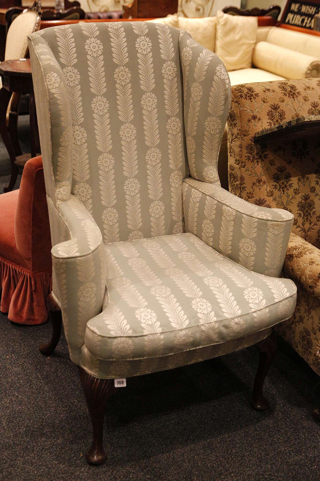 A small George I style wing armchair, upholstered