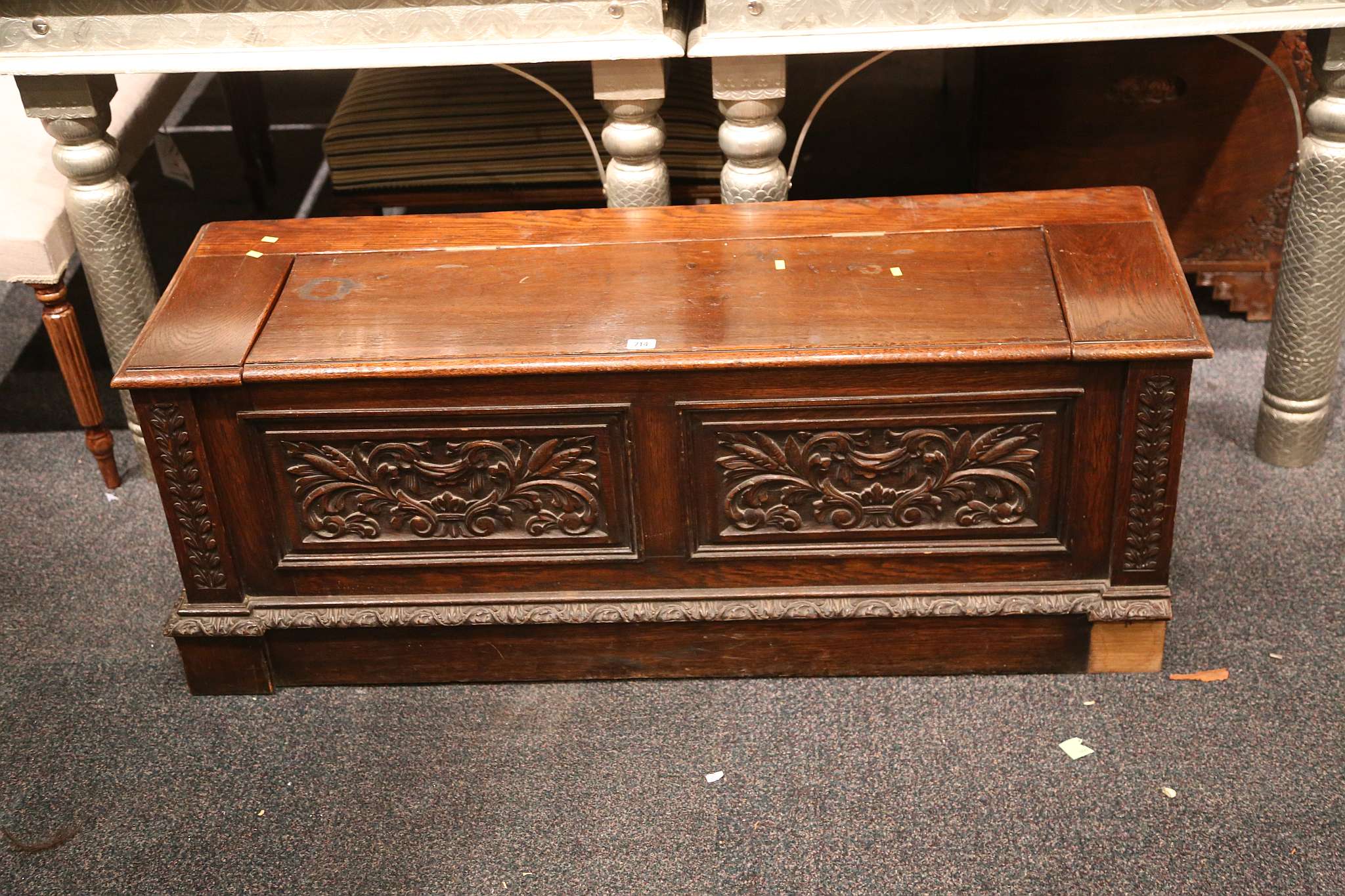 An antique oak coffer, with carved decoration to f