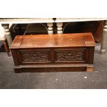 An antique oak coffer, with carved decoration to f