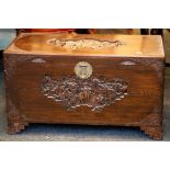 An oriental blanket box, figures and landscape carving to lid and front and floral carving to