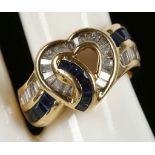 An 18ct yellow gold entwined baguette sapphire and baguette diamond ring
