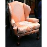 A George I style wing armchair, upholstered in ora