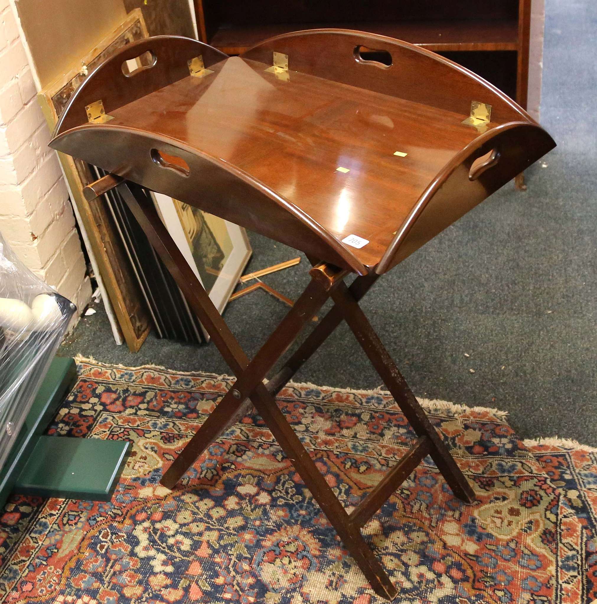 A mahogany butler's tray on folding stand