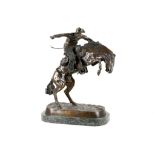 A 20th Century large bronze group of American cowboys on horseback, after Remington, raised on