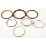 A collection of seven various silver bangles, including Victorian hinged and engraved examples,