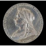 An 1897 silver diamond jubilee medallion, with veiled head / reverse with young head and date 1837