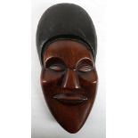 An African hardwood mask, possibly Bantu, early 20