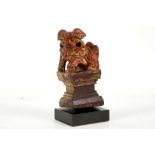 A Chinese, late Qing 19th Century, hard carved Buddhist lion dog, face grimacing, left foot raised