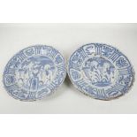 A pair of Chinese blue and white Kraak ware chargers, each decorated with boys within a central