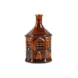 A Victorian gin bottle, in cottage form, treacle g