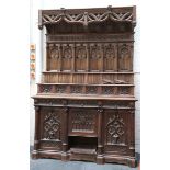 A Victorian Gothic oak dresser, having well carved