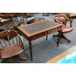 A walnut writing table with two frieze drawers, ra