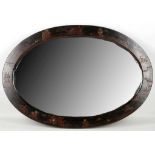 A Japanese lacquer oval mirror, figures, buildings