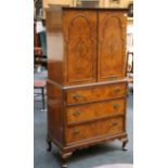 A 1930 walnut linen press, with two doors enclosin