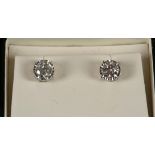 An 18ct white gold, large pair of screw back diamo