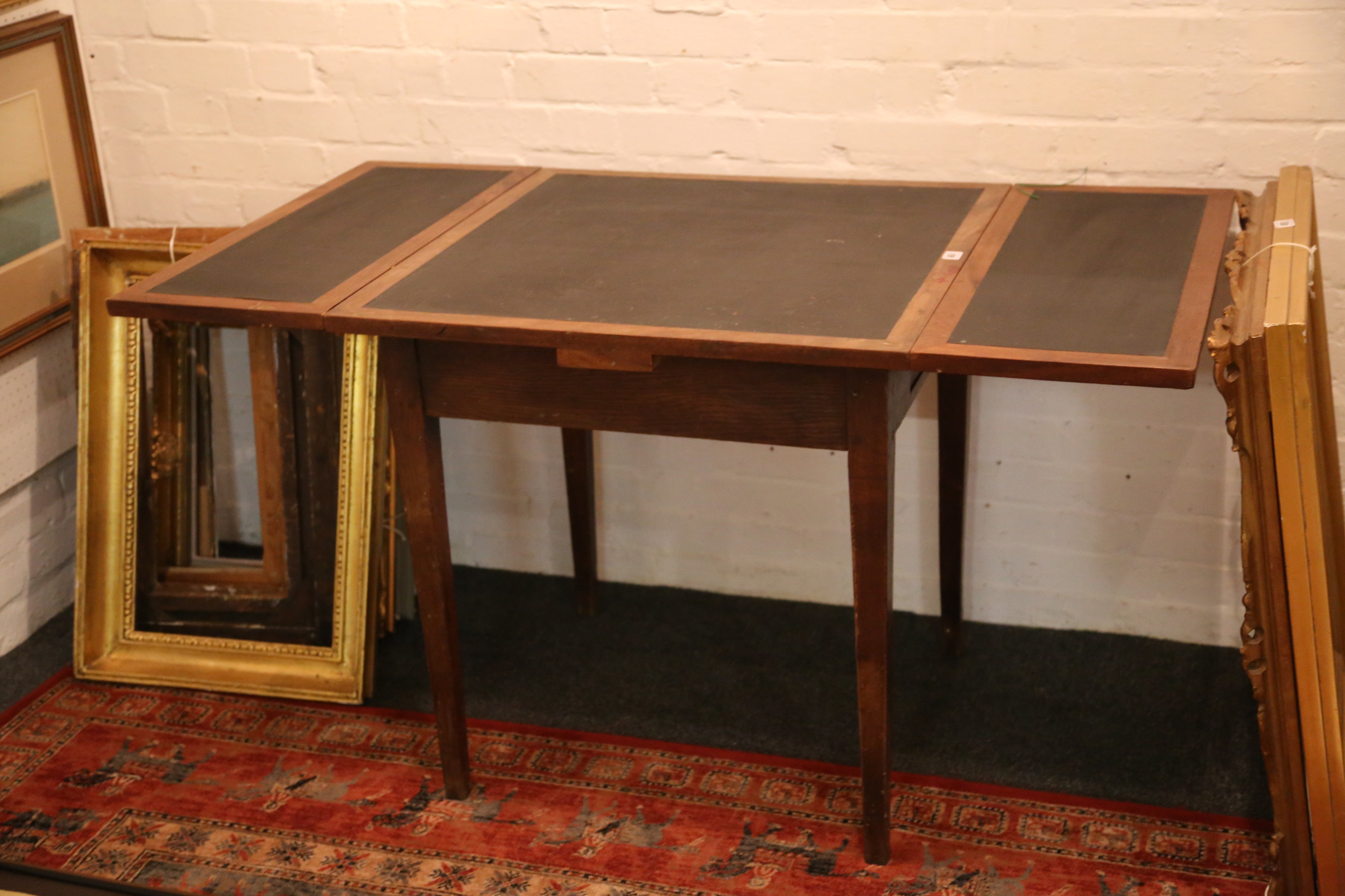 A 1920's draw leaf study table, mahogany with blac