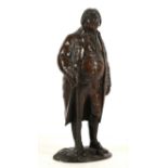 A bronze figure of an 18th Century gentleman in a