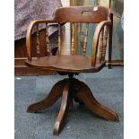 An oak Captain's chair, with spindle back rest, on