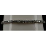 An 18ct white gold and diamond line bracelet, claw