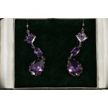 A pair of white metal mounted amethyst pendant ear