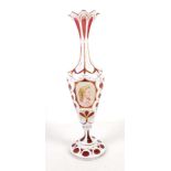 A late 19th Century Bohemian overlay stem vase, cranberry and milk glass with gilding, two panels,