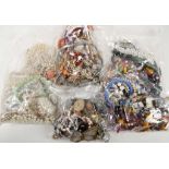 4 Bags of costume jewellery including African brac
