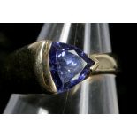 A 14k gold and tanzanite solitaire ring, the trill