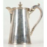 A George III silver hot water jug, top finial, bead decoration to lid, leaf thumb rests to handle,