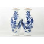 A pair of antique Chinese porcelain, baluster shaped, blue and white vases, painted with figures