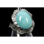 A platinum, cabouchon cut turquoise and diamond se