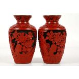 A pair of Chinese cinnabar lacquered baluster shaped vases, carved in high relief with scrolling