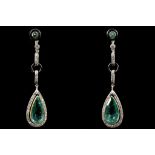 A fine pair of Art Deco emerald and diamond pendan